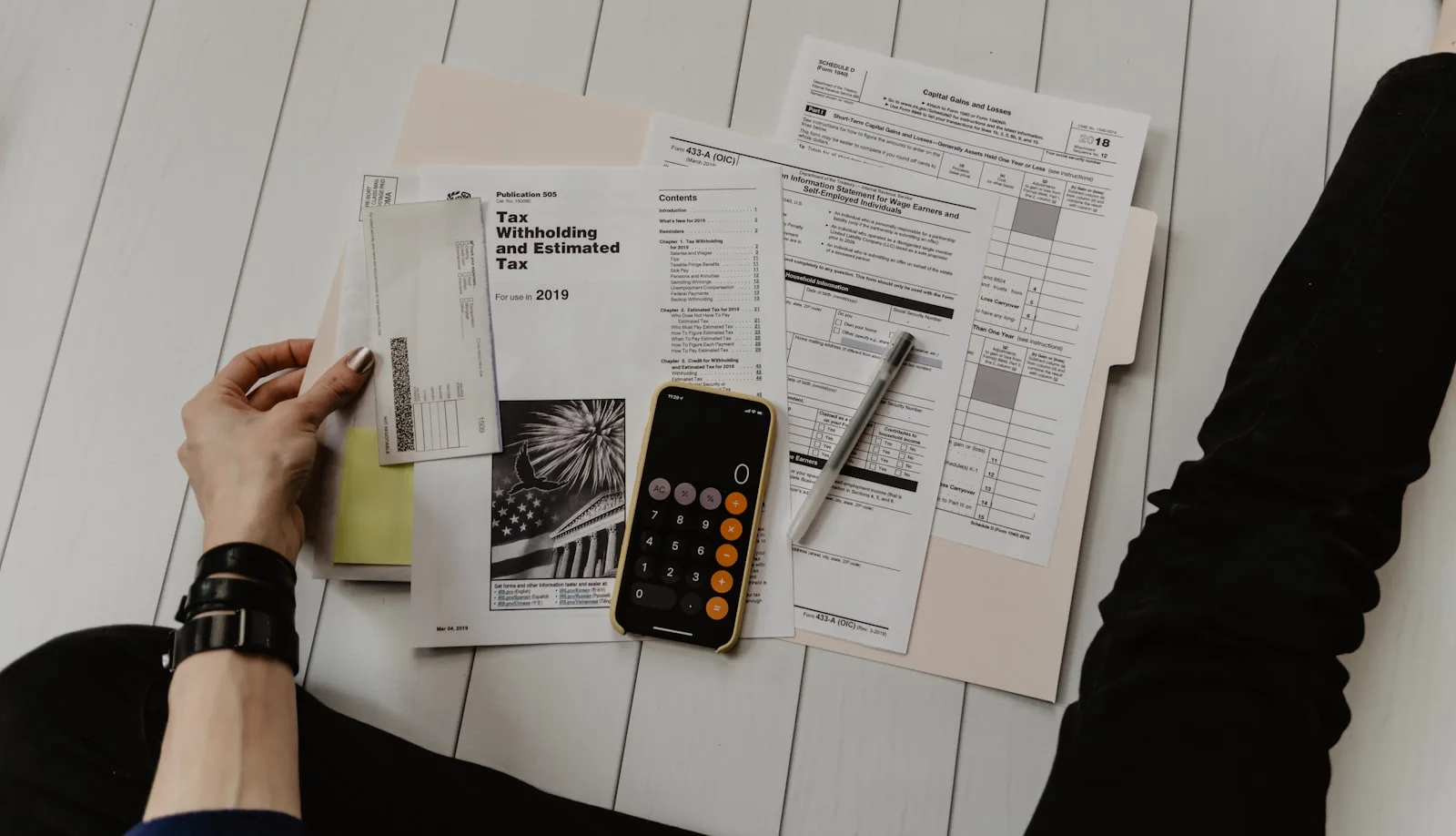 Calculator and tax documents laid out on a desk