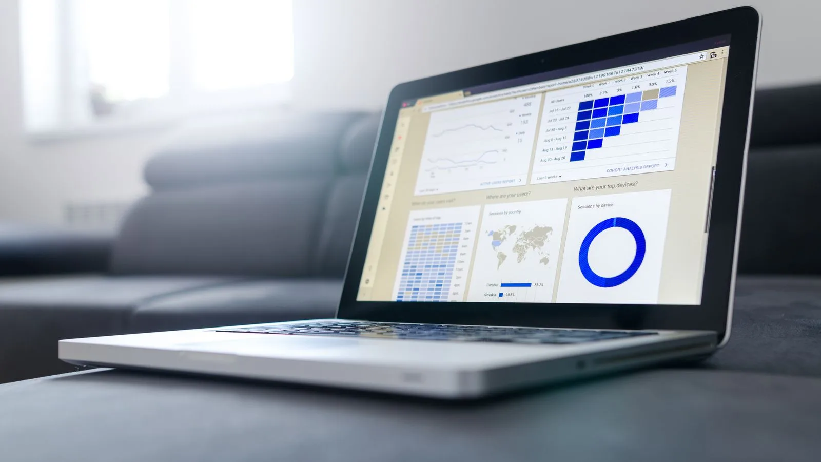 Sleek laptop showcasing data analytics and graphs on the screen in a bright room.