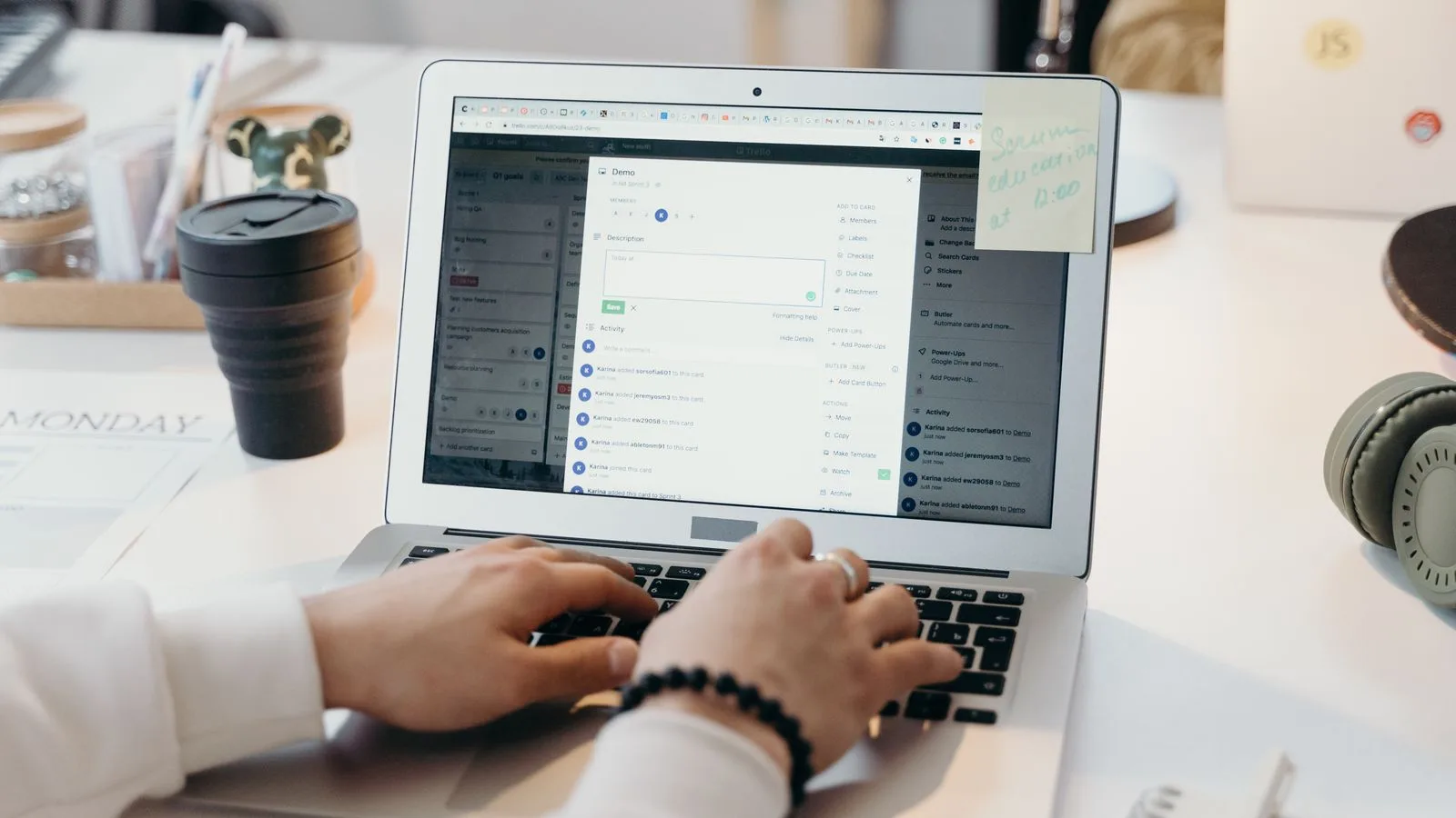A person typing on a laptop in a bright, modern office setting, showing productivity and technology.