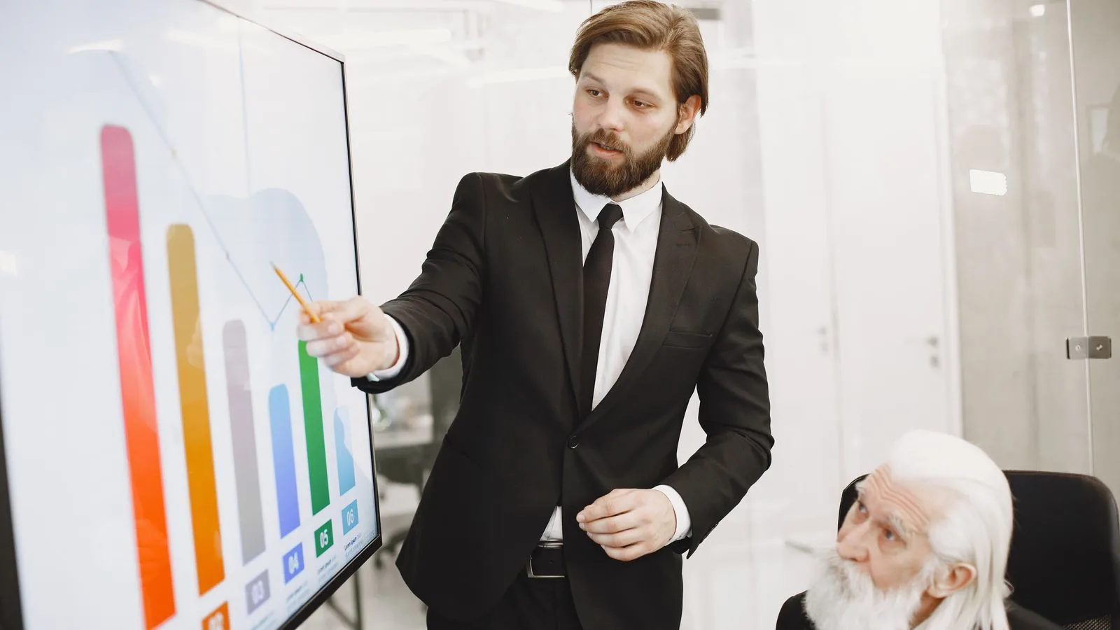 Two businessmen discussing data trends during a presentation in a modern office setting.