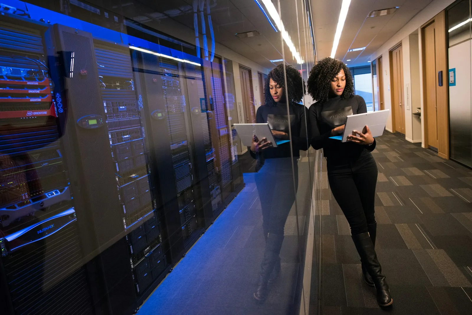 An IT professional working near a data center server rack