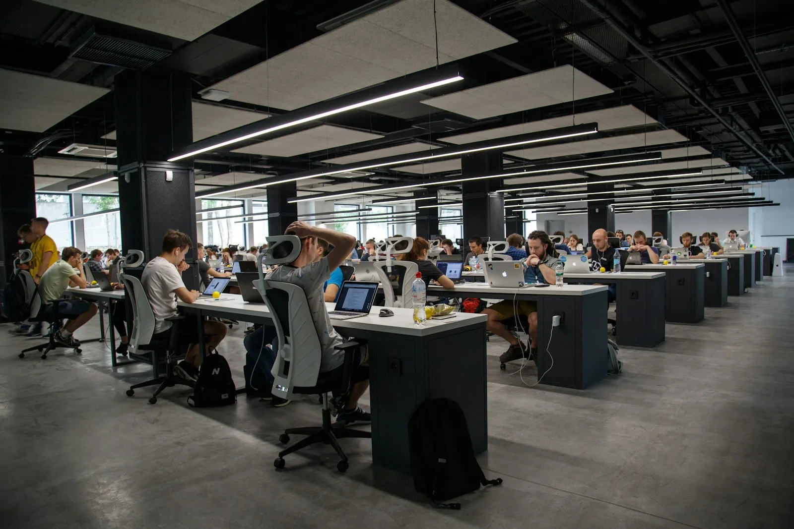 A large open-plan software development office full of engineers at desks
