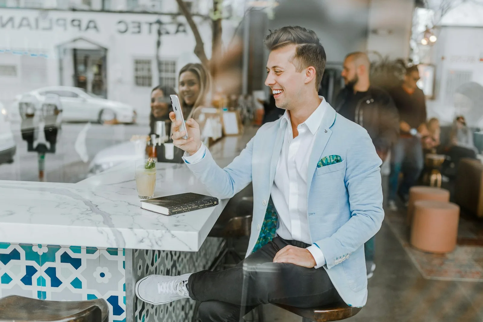 A smiling businessman sitting at a cafe table