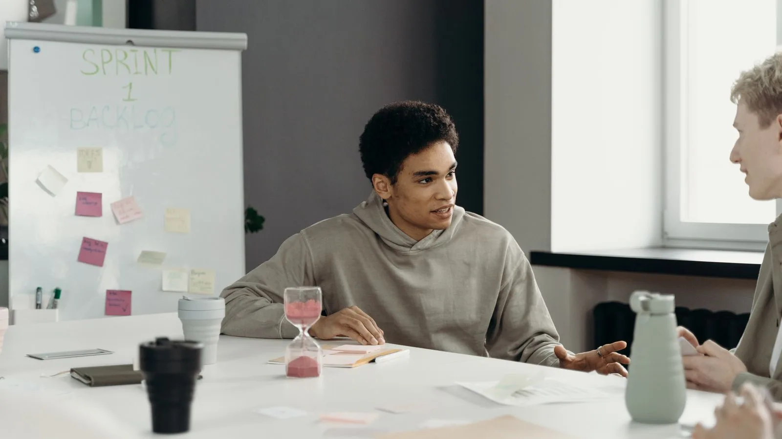 A diverse team engages in a productive office meeting, planning a project with teamwork and collaboration.